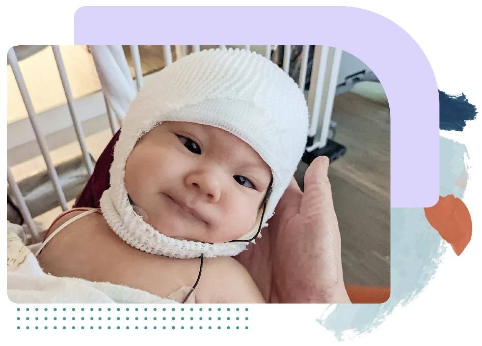 An infant wearing an EEG cap